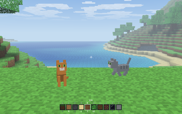 Two cats on the grass above a blue bay